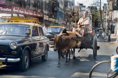 Crowded busy street with taxi cycle and bullock cart, Mumbai Bombay, Maharashtra, india clipart