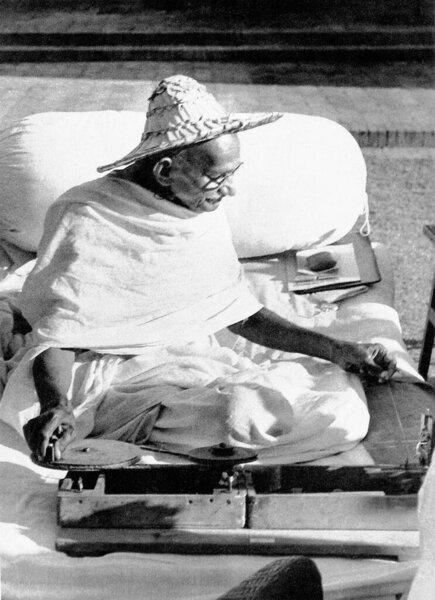 Mahatma Gandhi wearing a Noakhali hat whilst spinning at Birla House, New Delhi, India, November 1947   