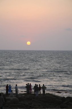 People watching sunset at Kanyakumari, Tamil Nadu, India  clipart