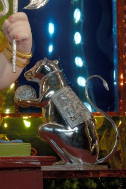 Silver mouse carrying ladoo ; vehicle of Lord Ganesh ; worshiping for Ganapati festival ; Jilbya Maruti Mandal ; Pune ; Maharashtra ; India clipart