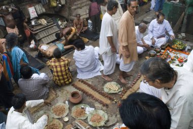 Bengalese Performing Shradha (last ritual) pooja Babu Ghat, Kolkata, West Bengal, India  clipart