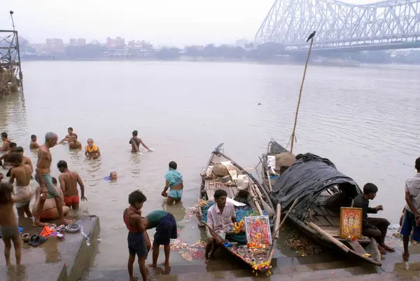 stock image People bathing at a Ghat at Howrah bridge ; Kolkata ; West Bengal ; India