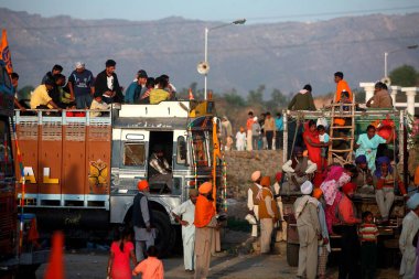 Devotees on board of truck during Hola Mahalla celebration in Anandpur sahib in Rupnagar district, Punjab, India  clipart