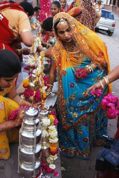 stock image Rajasthani Marwari women preparing silver lotiyan or metal pots on occasion of Gangaur ; Jodhpur ; Rajasthan ; India NO MR