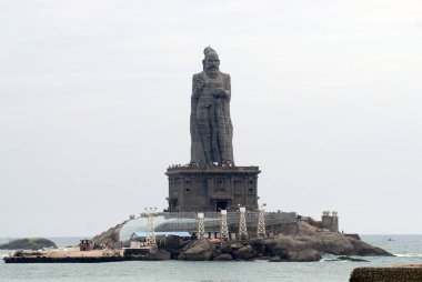Adjacent to Swami Vivekananda memorial stand 133ft statue of Thiruvalluvar honoured Tamil poet ; Kanyakumari ; Tamil Nadu ; India clipart