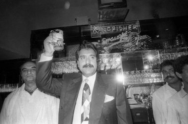 Vijay Mallya holding glass in bar clipart