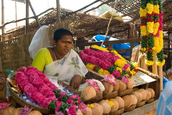 Thiruvannamalai Tapınağı 'ndaki tezgahta Pooja integrali satan bir kadın; Tamil Nadu; Hindistan