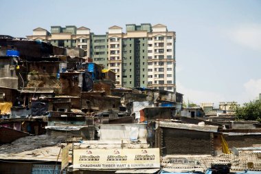 Rich and poor combination, slum and residential building at Kandivali, Mumbai Bombay, Maharashtra, India  clipart