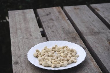 Dry Fruits Cashew Nuts in plate at Koti near Simla , Himachal Pradesh , India clipart