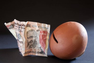 Indian Currency with Earthen Mud Pot India