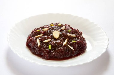 Indian food ; sweet dessert chukandar lal salgum ka halwa vegetables beetroot fudge porridge clipart