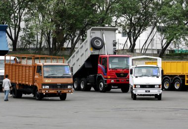 Various commercial products like matadors, trucks parked at Tata motors plant, Pimpri near Pune, Maharashtra, India  clipart