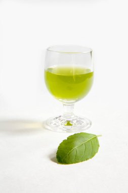 Kutsal Basil bitkisi Tulsi yaprakları ve bir bardak meyve suyu. 