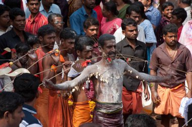 Devotees piercing body with skewers holding trident in mouth in kavadiatam thaipooyam thaippooyam festival, Kottayakunn, Nedumgolam, Quilon Kollam, Kerala, India 2010  clipart