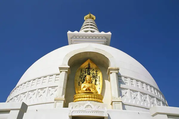 stock image Golden idol of Buddha on Vishwa Shanti stupa, Rajgir, Bihar, India 