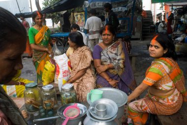 Women having tea on roadside tea vendor, Kolkata, West Bengal, India  clipart