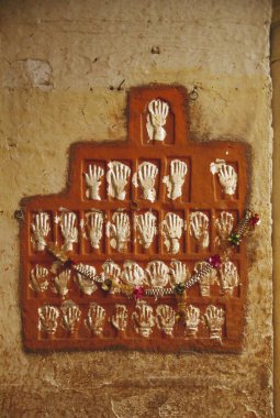 Sati stone hands marks spot of self immolation by woman in Meherangarh fort , Jodhpur , Rajasthan , India clipart