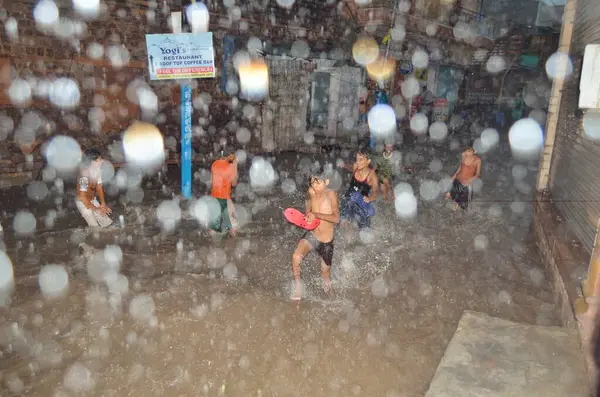 stock image Boys try escape flood of water on road Makrana Mohalla monsoon Jodhpur Rajasthan India Asia 