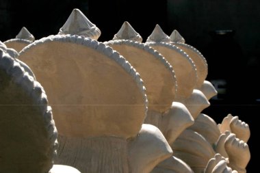 Lord Ganesh 'in beyaz putlarının soyut desenleri Tanrı' ya arkadan yöneldi ve kuruması için güneş ışığında düzenlendi; Pune; Maharashtra; Hindistan