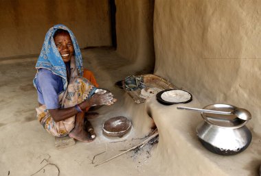 Rural woman cooking food ; Rajouli ; Nawada ; Bihar ; India clipart