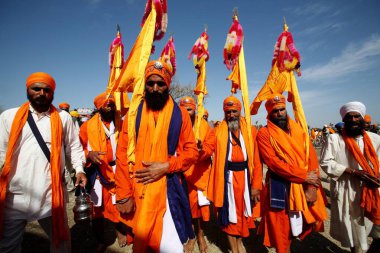 Sikh guru Panj Pyaare five beloved leading procession and carrying holy nishansahib in Anandpur sahib in Rupnagar district, Punjab, India  clipart