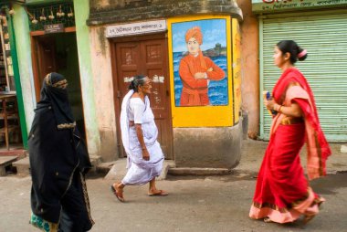 People walking in front of Swami Vivekananda Wall paining; Kolkata ; West Bengal ; India clipart