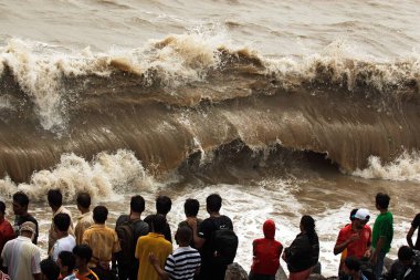 People enjoying hightide waves at marine drive Bombay , Mumbai , Maharashtra , India clipart