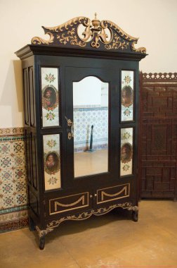 Wooden decorated cupboard in scindia museum in jaivilas palace, Gwalior, Madhya Pradesh, India  clipart