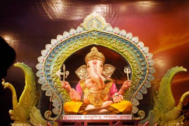 Richly decorated idol of Lord Ganesh elephant headed god ; Ganapati festival at Babu Genu Mandal ; Pune ; Maharashtra ; India clipart