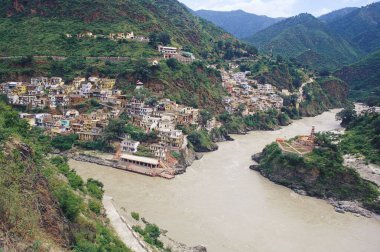 Sacred rivers meet at rudraprayag, uttaranchal, india  clipart