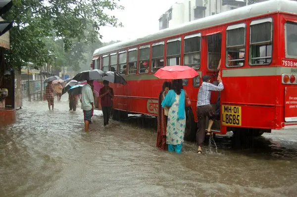 stock image People boarding bus in heavy rain on June 2006 at Bombay Mumbai, Maharashtra, India 