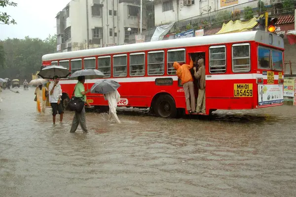 stock image People boarding bus in heavy rain on June 2006 at Bombay Mumbai, Maharashtra, India 