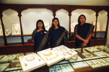 Saleswomen showing Sukho Thai Jewellery in shop, Bombay Mumbai, Maharashtra, India   clipart