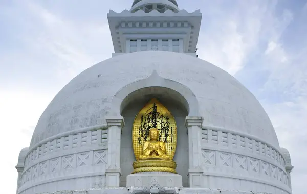 stock image Golden statue of lord Gautam Buddha, Buddhist site, Vishwa Shanti (World Peace) stupa, Rajgir, Bihar, India 