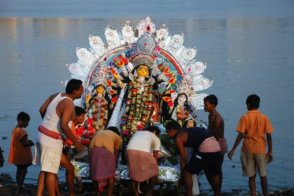 stock image Devotees immersing Durga model in river 