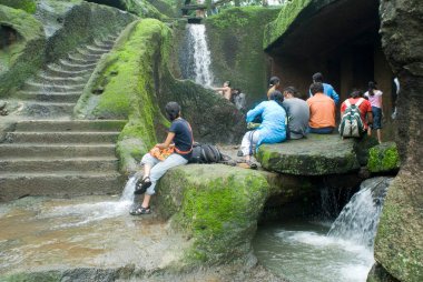 Tourist at waterfall of Kanheri caves built in 1st Century B.C. to 9th Century A.D., Borivali, Bombay Mumbai, Maharashtra, India clipart