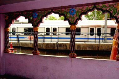 Metro train  seen from inside of hanuman temple panchkuan road ; New Delhi ; India clipart