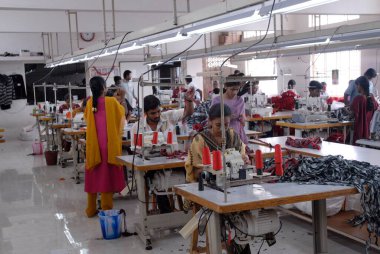 Stitching in a garment industry ; Tirupur ; Tamil Nadu ; India clipart