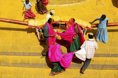 Two newly wed couples paying their obedience at the famous Jejuri temple ; pune ; Maharashtra ; India clipart