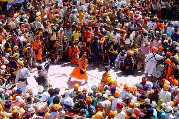 stock image Nihang or Sikh warriors performing stunts with swords in during Hola Mohalla celebrations at Anandpur sahib in Rupnagar district, Punjab, India  