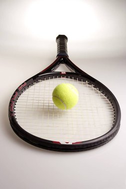 Tenis topu yeşili raketle.