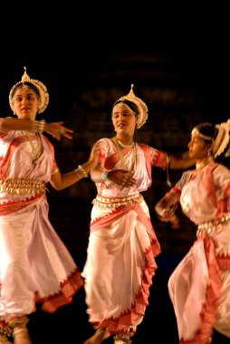 Odissi dancers enact scene in traditional ballet staged annually in Konarak, Orissa  clipart