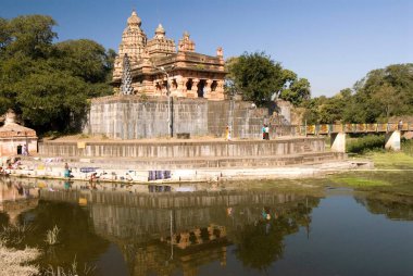 Sangemeshvar, lord shankar shiva temple on bank of river karha & chamblis confluence, women washing cloth on ghat at Sasvad village, taluka Purandar, district Pune, Maharashtra, India  clipart