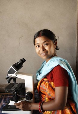 Woman operating binocular ; NGO Action North-east Trust (ANT) ; Bongaigaon ; Assam ; India clipart