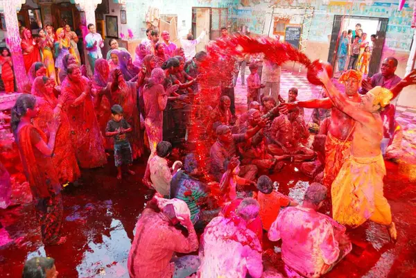 Stock image Priest pouring colour water on devotees Rangpanchmi Rajasthan India Asia   