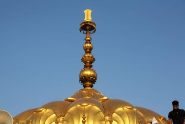 Golden tomb of the Sachkhand Saheb Gurudwara with Khanda Sikh weapon, 300th year of Consecration of perpetual Guru Granth Sahib on 30th October 2008, Nanded, Maharashtra, India  clipart