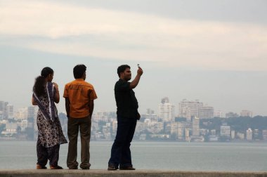 Denizcilik Yolu, Bombay Bombası, Maharashtra ve Hindistan 'ın fotoğraflarını çeken bir çift ayakta duruyor.