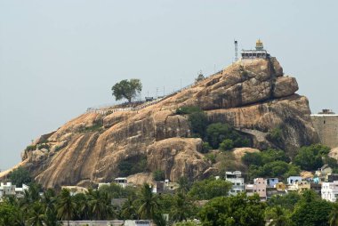 The 83m high Rock Fort which is 3;800 million years old and Uchipillaiyar Koil temple dedicated to Lord Ganesh ; Tiruchirappalli ; Tamil Nadu ; India clipart
