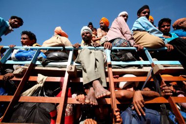 Devotees onboard of truck after Hola Mohalla festival in Anandpur sahib in Rupnagar district, Punjab, India   clipart