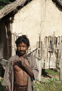 Man standing near house ; Bongaigaon ; Assam ; India clipart